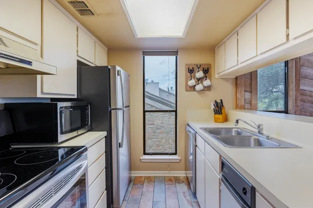 a kitchen with appliances and cabinets