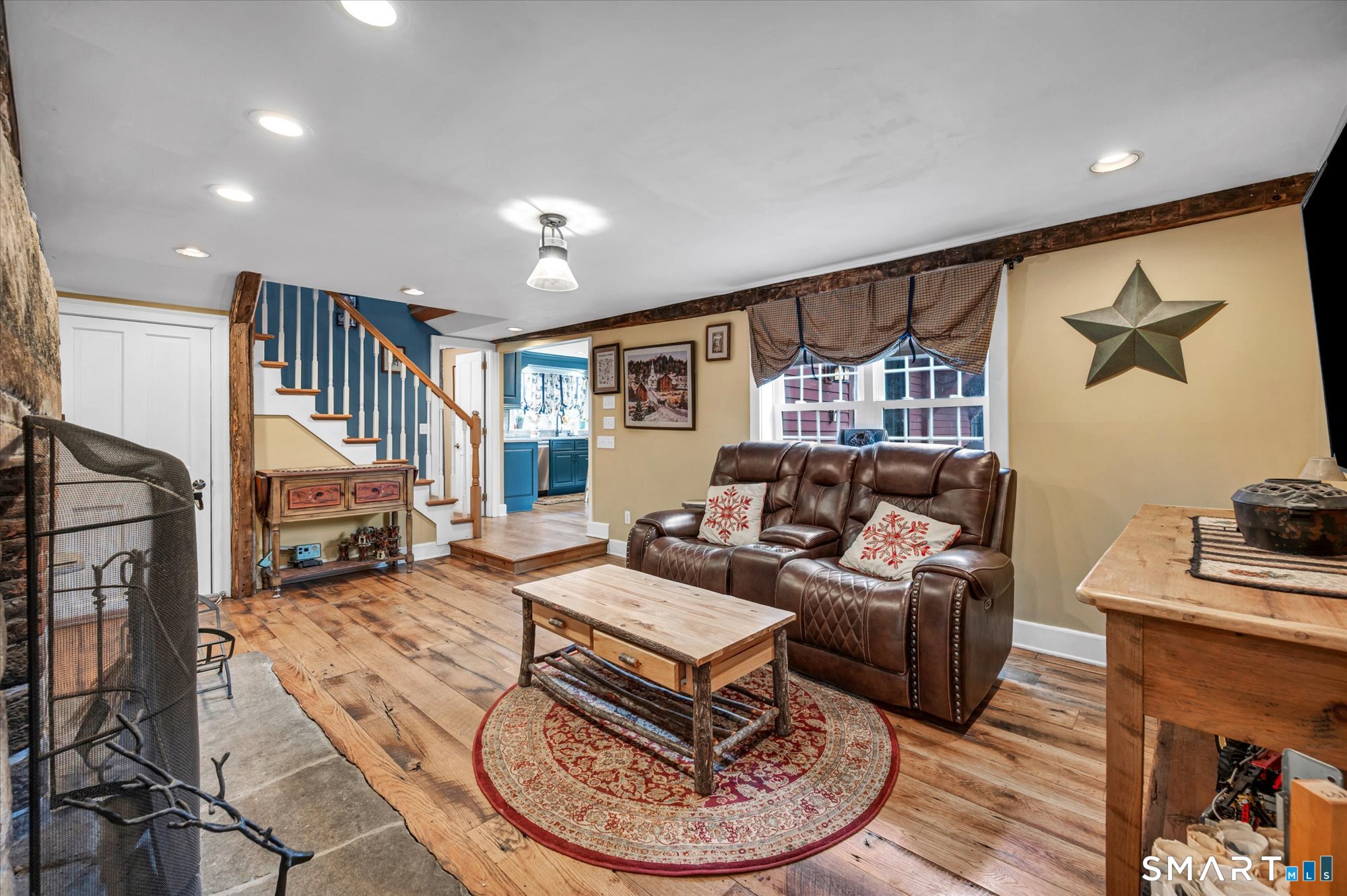 566 Maple Street Litchfield, CT 06759 - Photo 15 of 34 a living room with furniture a fireplace and a flat screen tv