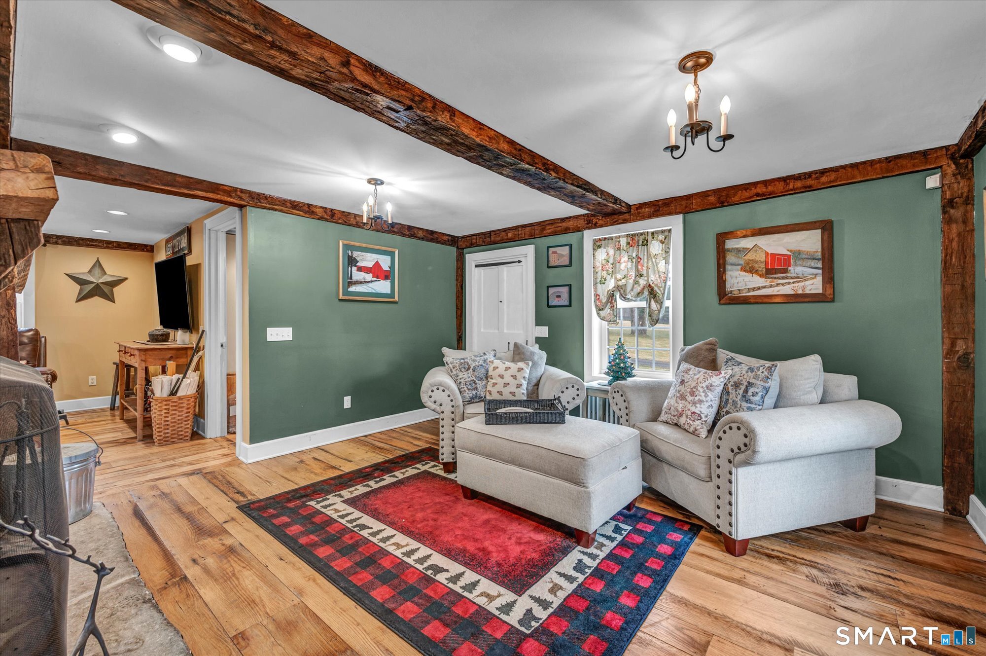 566 Maple Street Litchfield, CT 06759 - Photo 16 of 34 a living room with furniture and a chandelier