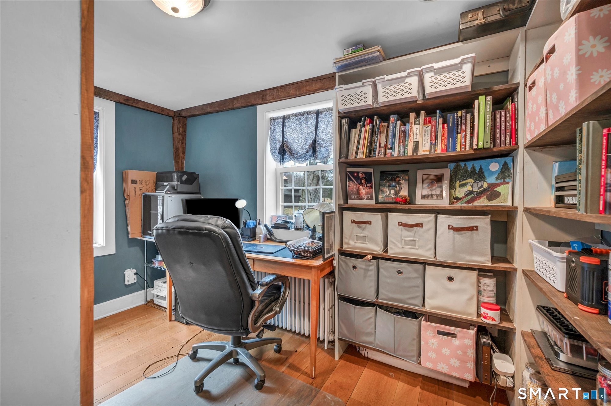 566 Maple Street Litchfield, CT 06759 - Photo 21 of 34 a view of a workspace with furniture and a book shelf