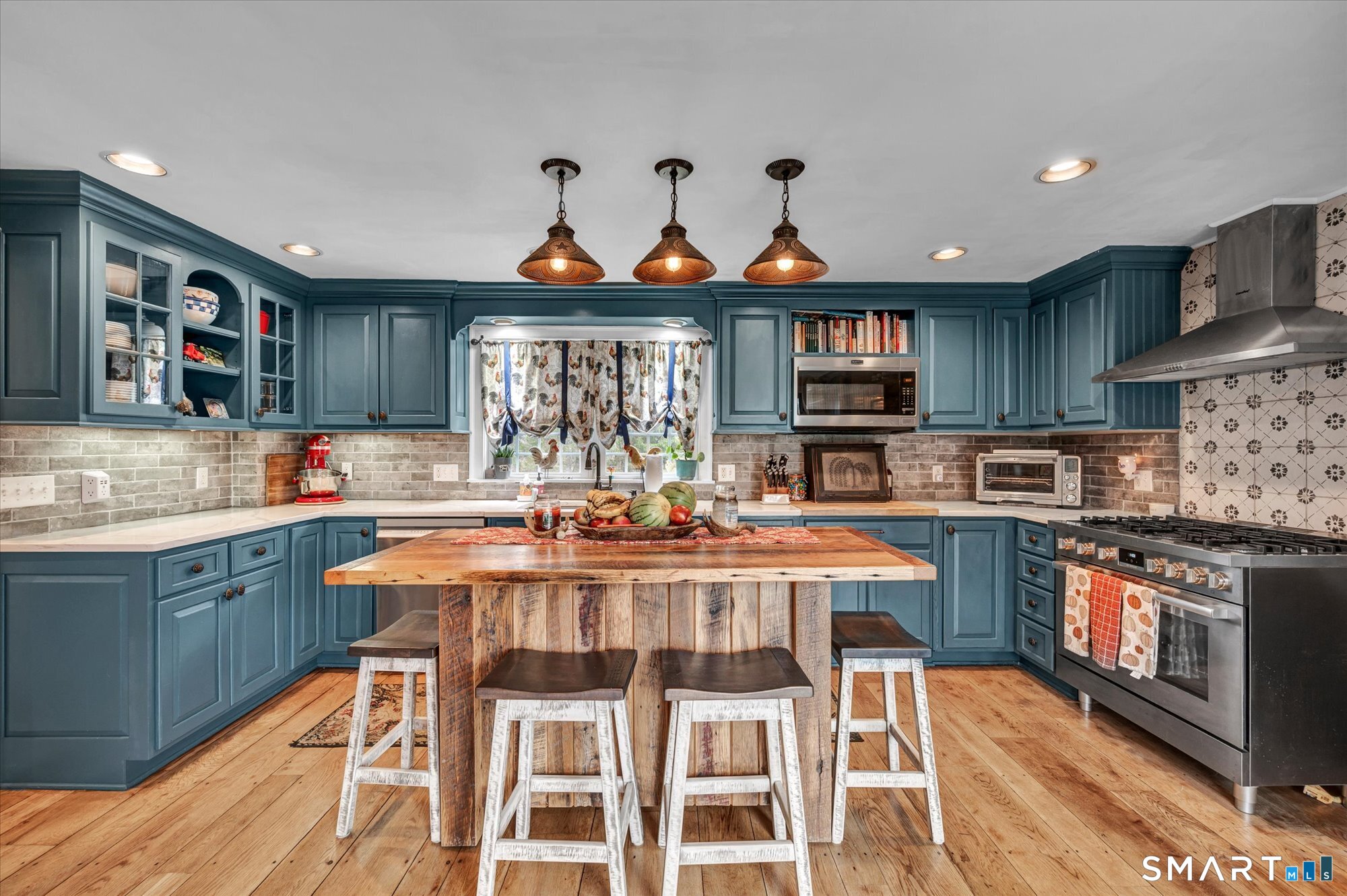 566 Maple Street Litchfield, CT 06759 - Photo 7 of 34 a kitchen with stainless steel appliances granite countertop a stove top oven a sink dishwasher and cabinets with wooden floor