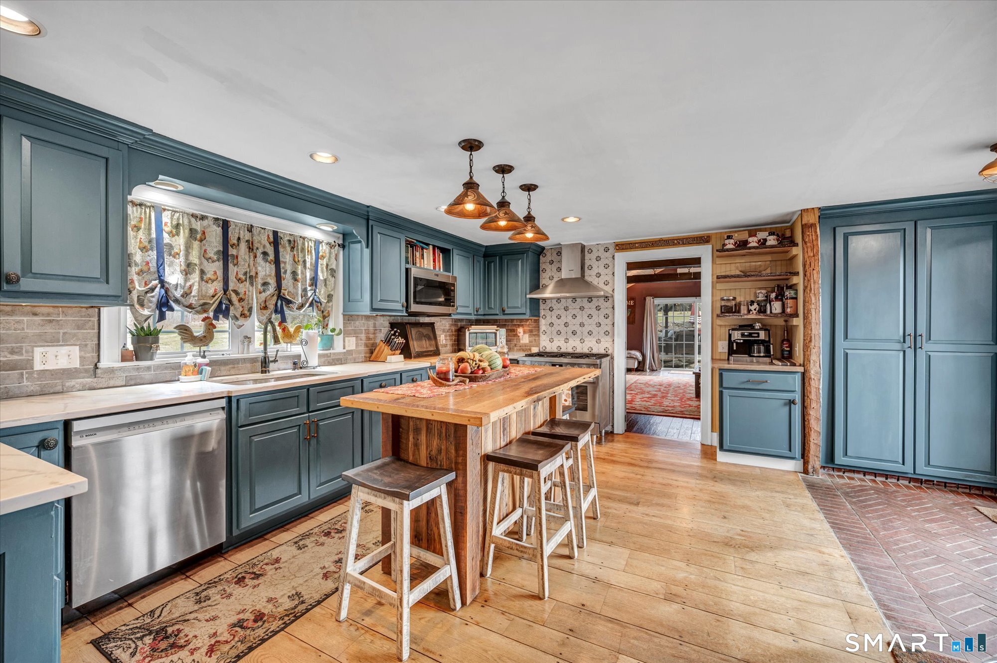 566 Maple Street Litchfield, CT 06759 - Photo 8 of 34 a kitchen with stainless steel appliances granite countertop a stove top oven a sink dishwasher and a refrigerator with wooden cabinets