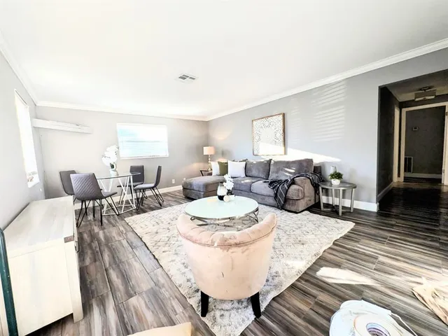 a living room with furniture a fireplace and a table