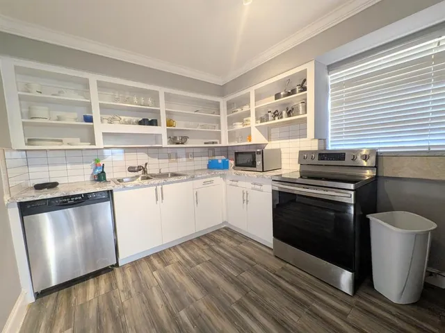 a kitchen with a sink and steel appliances