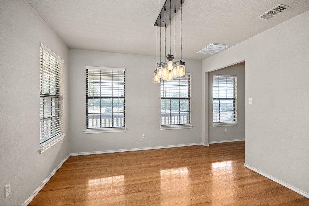 160 Rhum Road Kerrville, TX 78028 - Photo 12 of 42 a view of an empty room with wooden floor and a window