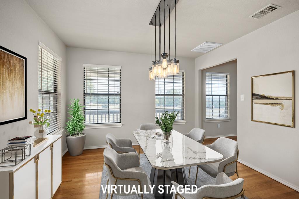 160 Rhum Road Kerrville, TX 78028 - Photo 13 of 42 a view of a dining room with furniture a chandelier and wooden floor