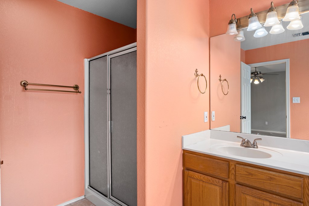 160 Rhum Road Kerrville, TX 78028 - Photo 17 of 42 a bathroom with a granite countertop sink and a mirror
