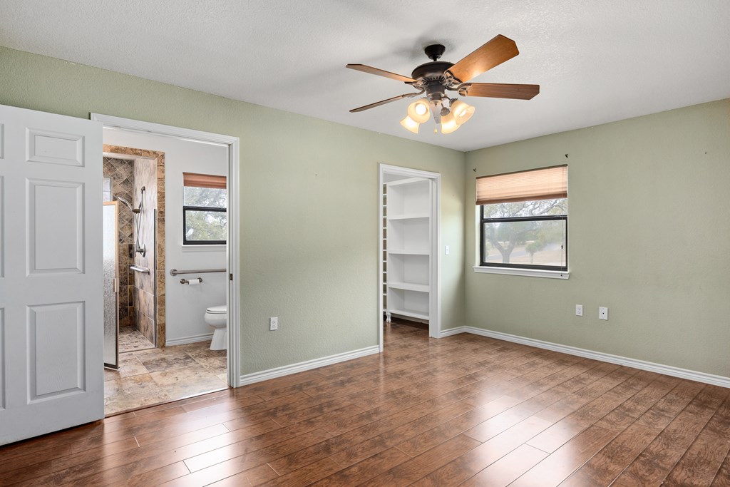 160 Rhum Road Kerrville, TX 78028 - Photo 18 of 42 wooden floor in an empty room with a window