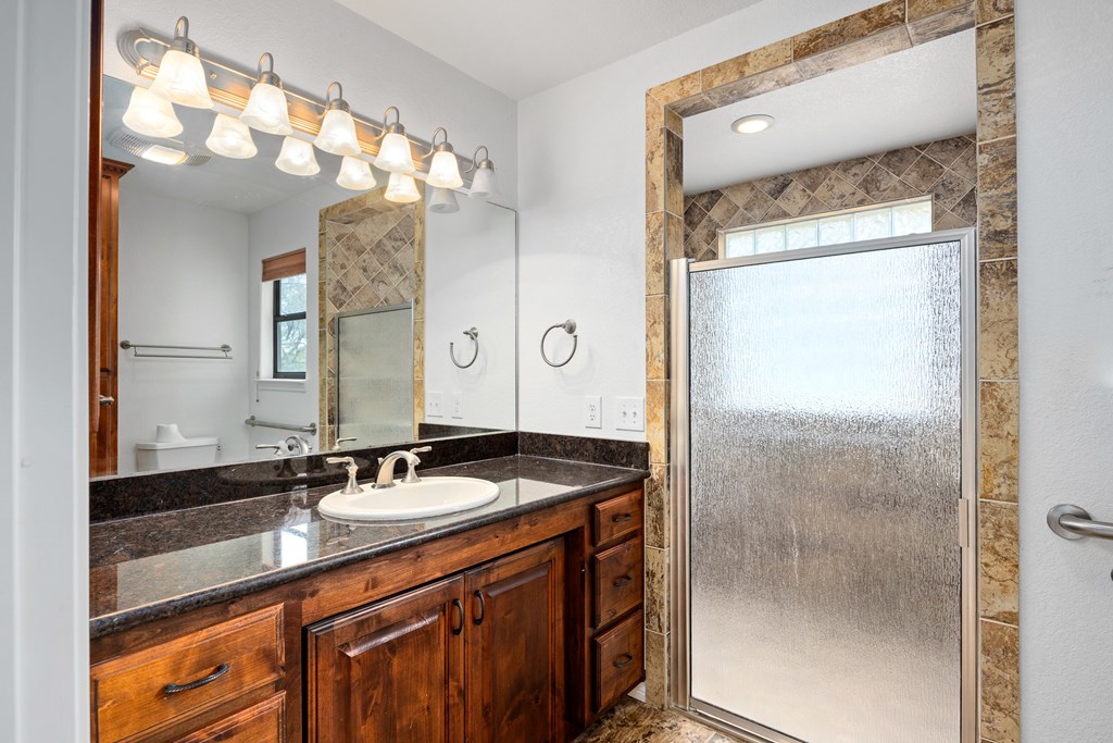 160 Rhum Road Kerrville, TX 78028 - Photo 19 of 42 a bathroom with a granite countertop sink and a mirror