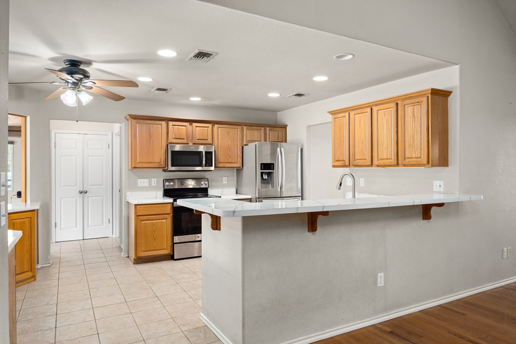 160 Rhum Road Kerrville, TX 78028 - Photo 9 of 42 a kitchen with stainless steel appliances granite countertop a stove sink and cabinets