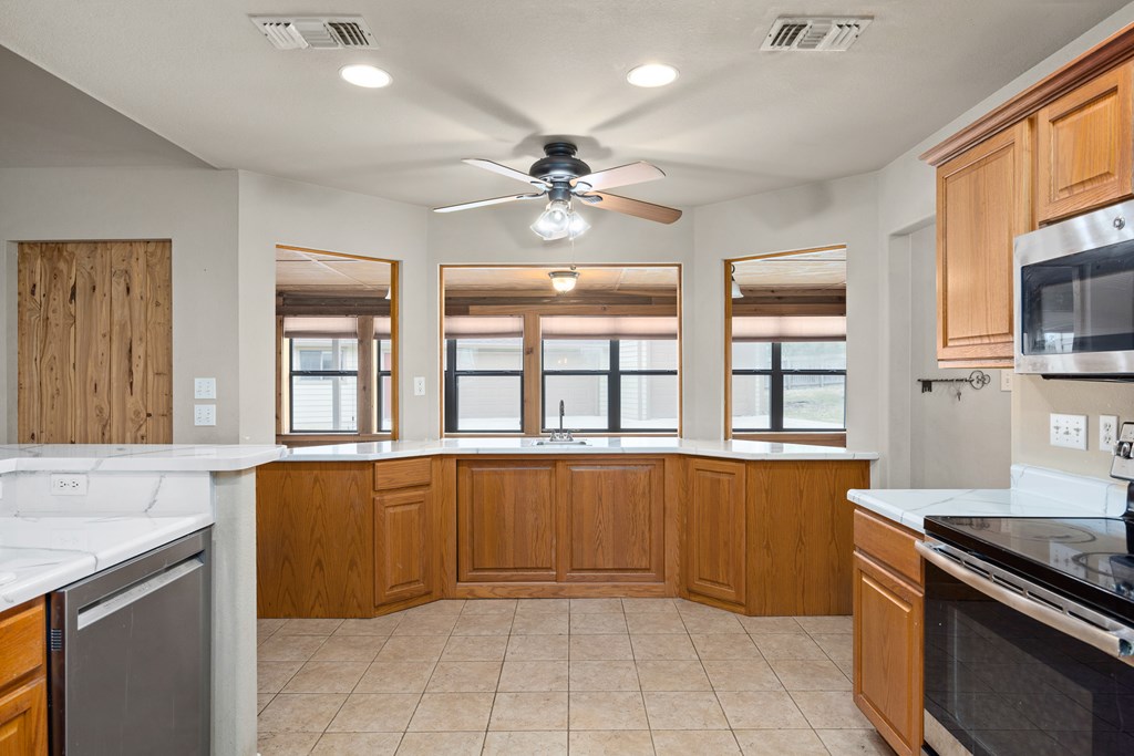 160 Rhum Road Kerrville, TX 78028 - Photo 10 of 42 a kitchen with stainless steel appliances granite countertop a stove and a sink