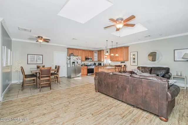 a living room with furniture and kitchen view