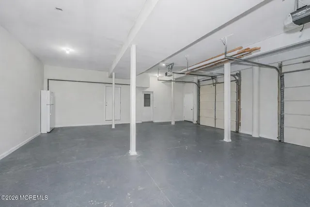 a living room with furniture and a book shelf