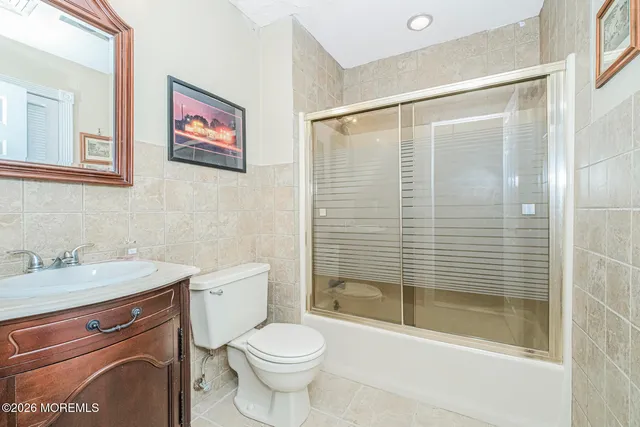 a living room with furniture and a book shelf