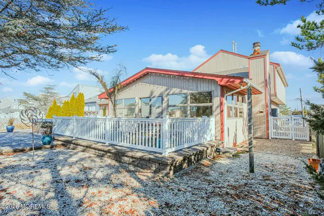 a view of a brick house with large trees