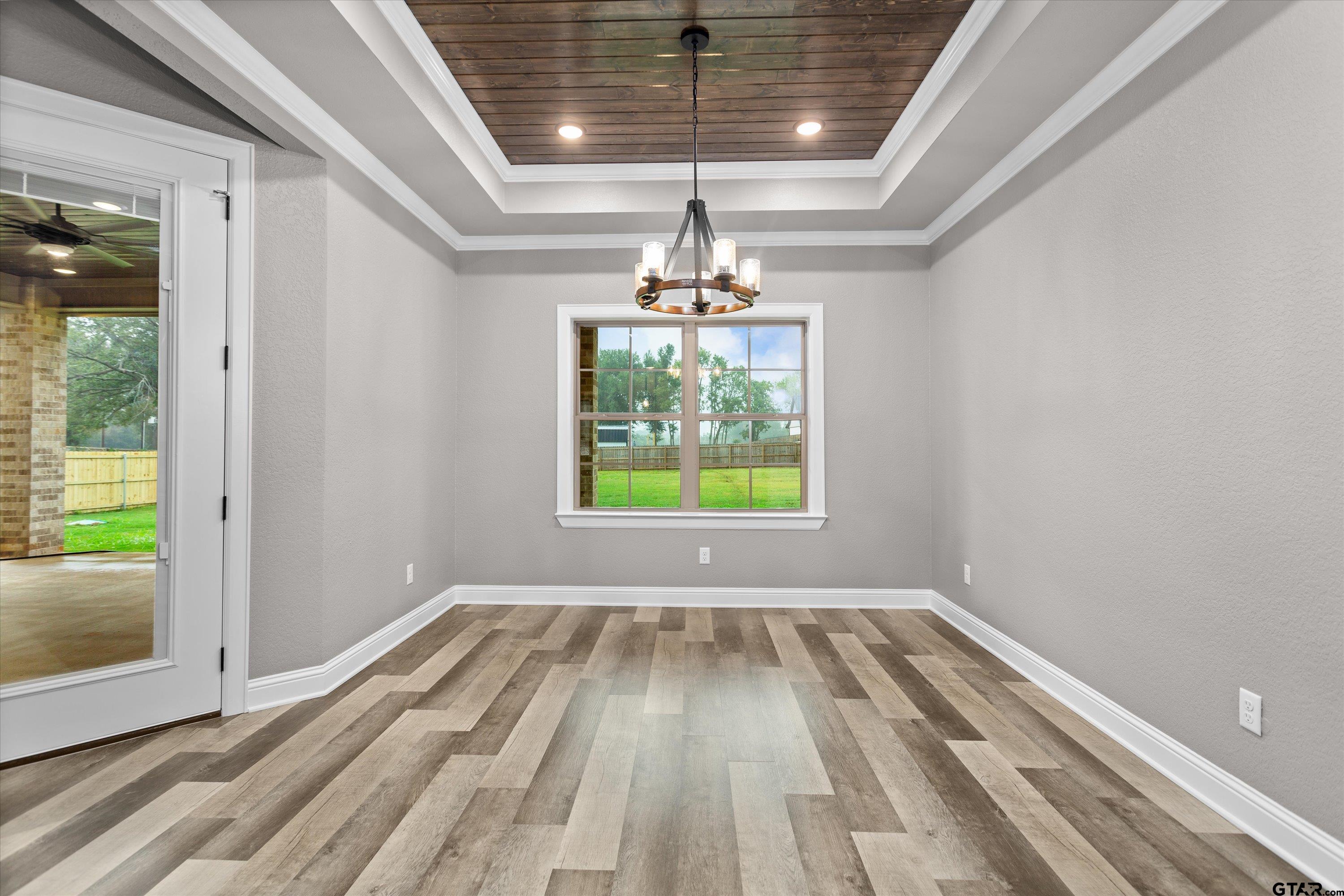 8527 Freestone Drive Bullard, TX 75757 - Photo 11 of 21 a view of empty room with wooden floor and fan