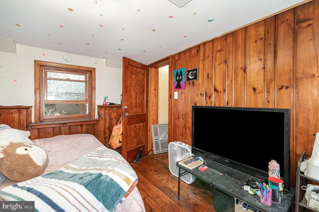 a bedroom with furniture and a flat screen tv