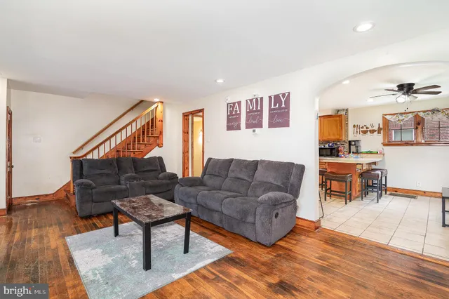 a living room with furniture and wooden floor