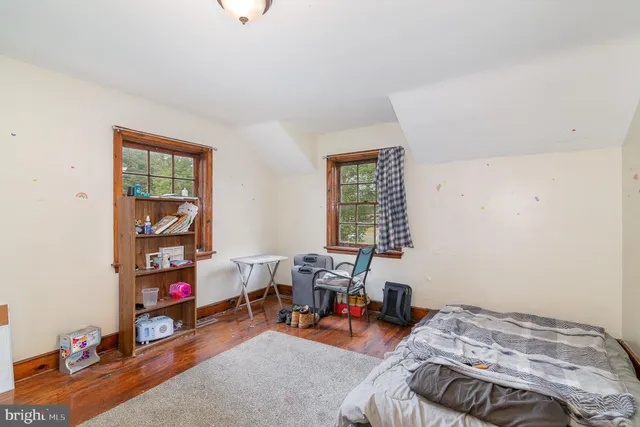 a bedroom with bed and a window