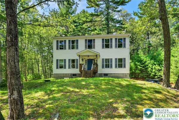 a house view with a sitting space and garden