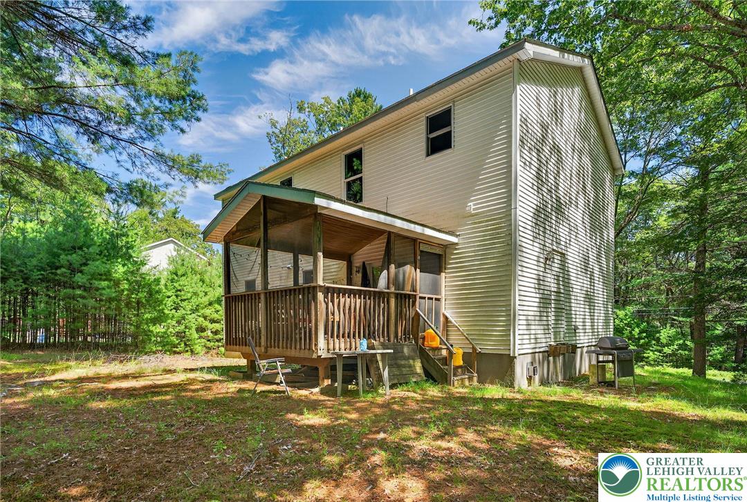 375 Marcel Drive Dingmans Ferry, PA 18328 - Photo 24 of 37 a backyard of a house with table and chairs