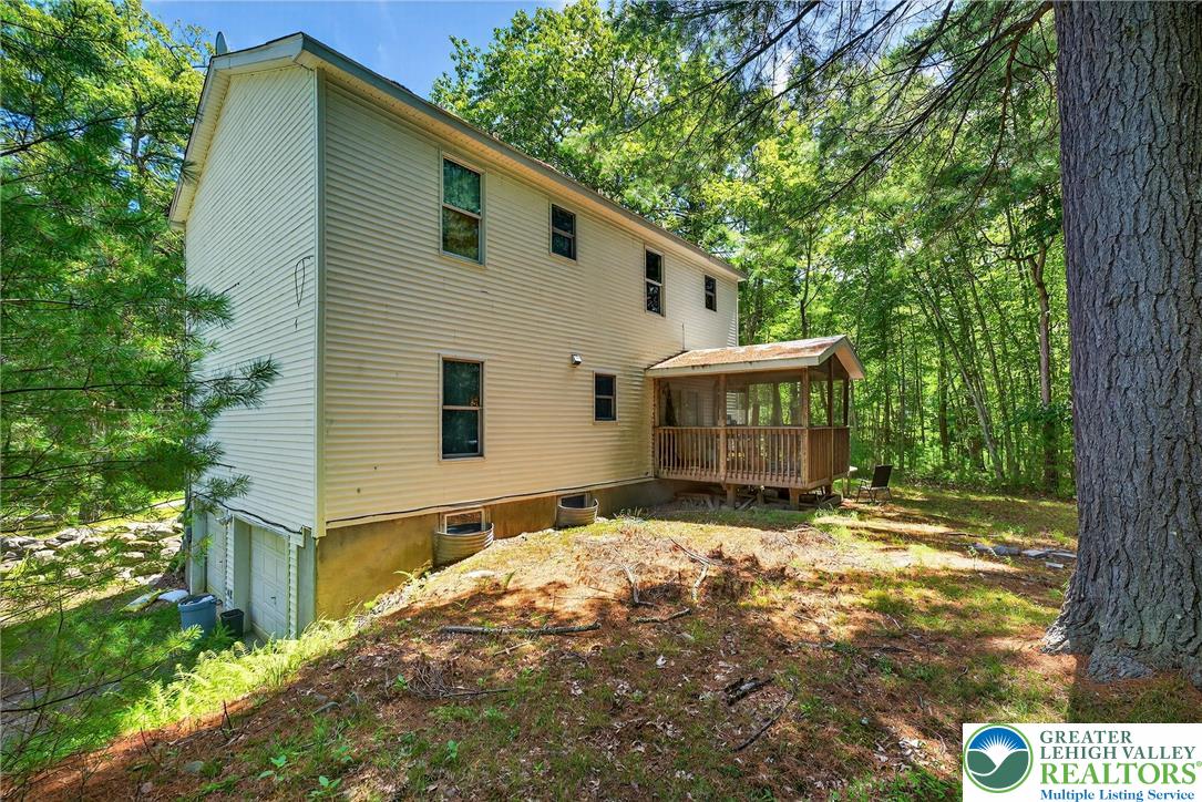 375 Marcel Drive Dingmans Ferry, PA 18328 - Photo 25 of 37 a view of house with yard and sitting area