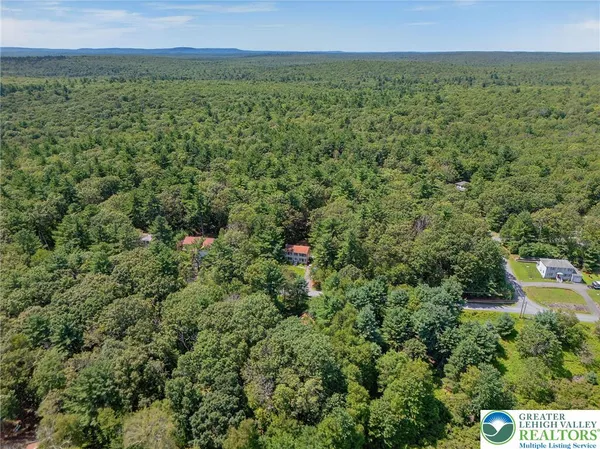 an aerial view of a houses with a yard