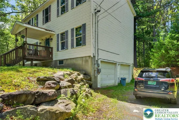 a view of a house with a yard and sitting area