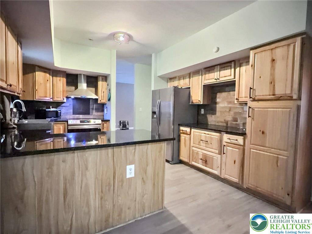 375 Marcel Drive Dingmans Ferry, PA 18328 - Photo 6 of 37 a kitchen with stainless steel appliances granite countertop a refrigerator a sink and white cabinets