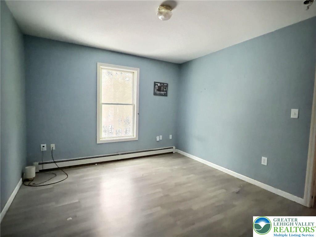 375 Marcel Drive Dingmans Ferry, PA 18328 - Photo 8 of 37 an empty room with wooden floor and windows