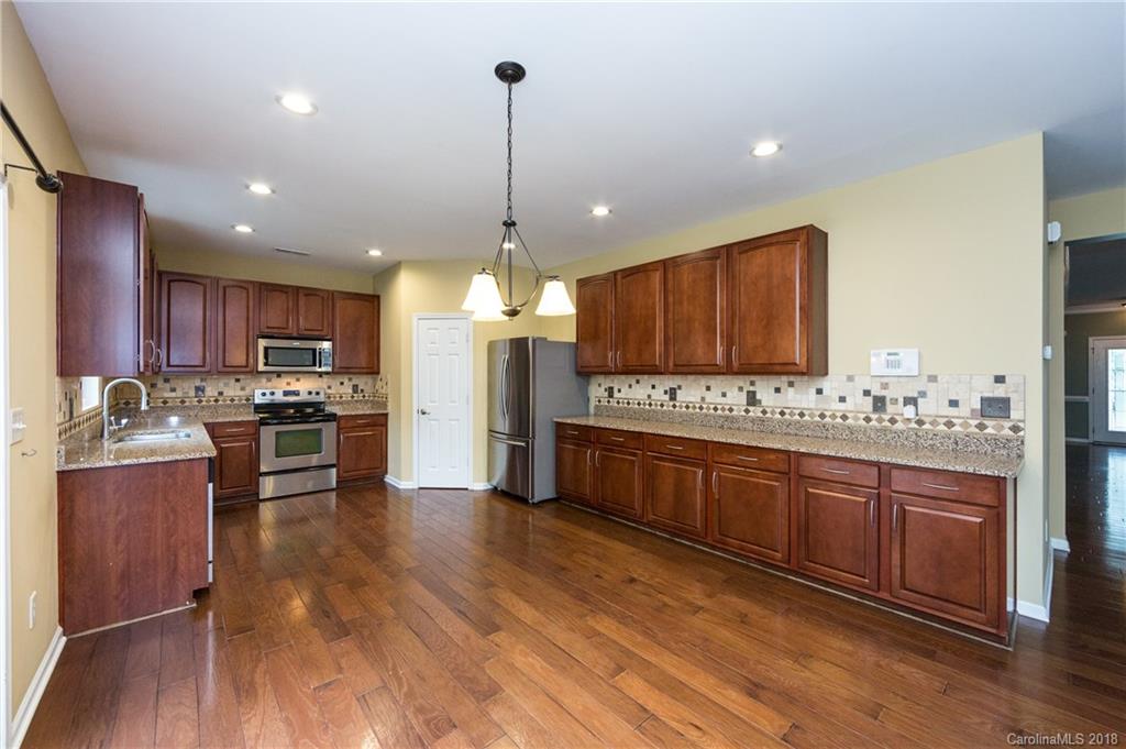 1132 Spicewood Pines Road Fort Mill, SC 29708 - Photo 11 of 24 a large kitchen with stainless steel appliances and wooden floor