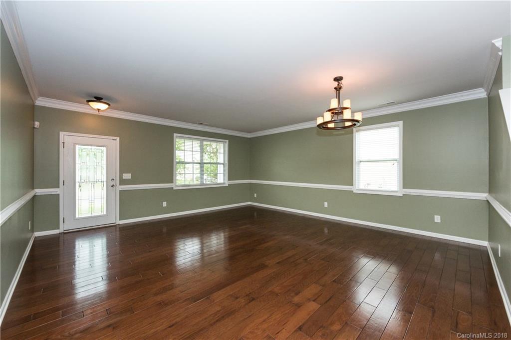 1132 Spicewood Pines Road Fort Mill, SC 29708 - Photo 3 of 24 a view of an empty room with wooden floor and a window