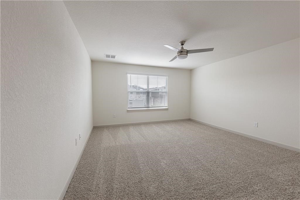 1801 Bonham Lane Round Rock, TX 78664 - Photo 11 of 24 an empty room with windows and ceiling fan