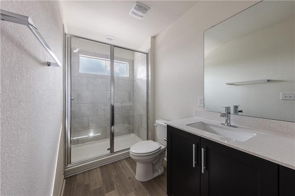 1801 Bonham Lane Round Rock, TX 78664 - Photo 13 of 24 a bathroom with a sink a toilet and shower
