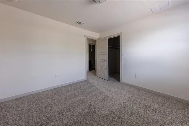 a view of an empty room with closet