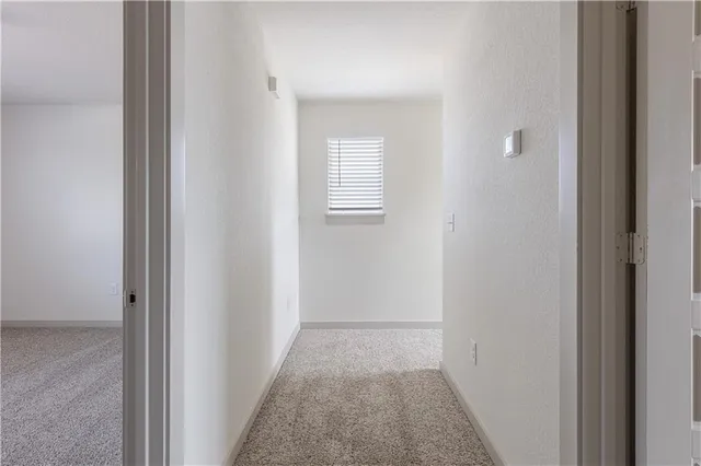 a view of a hallway with a white walls