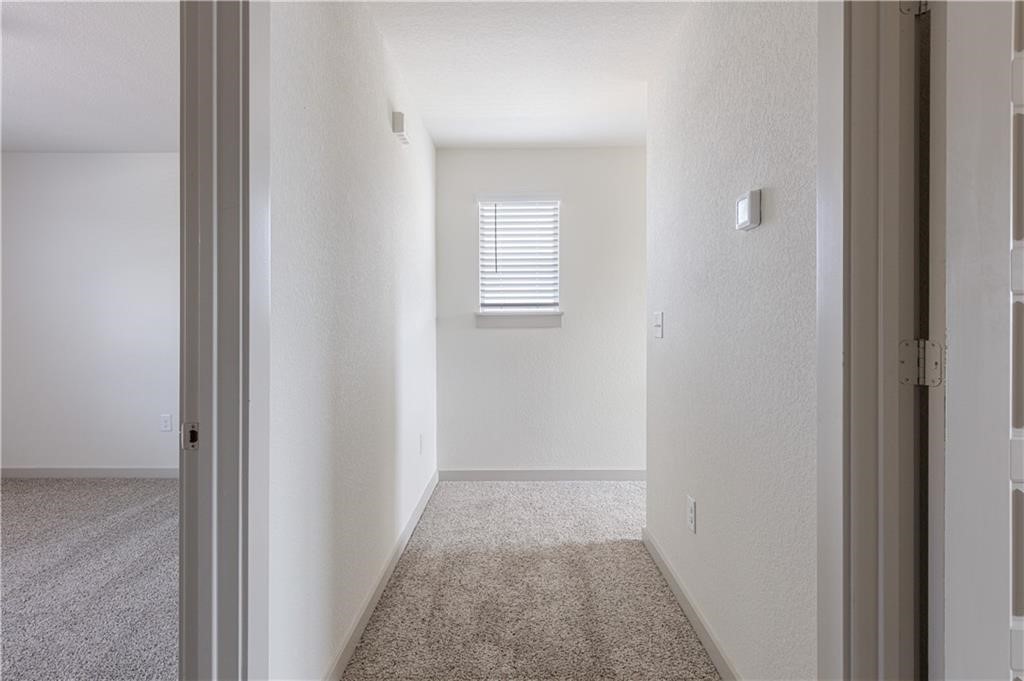 1801 Bonham Lane Round Rock, TX 78664 - Photo 21 of 24 a view of a hallway with a white walls