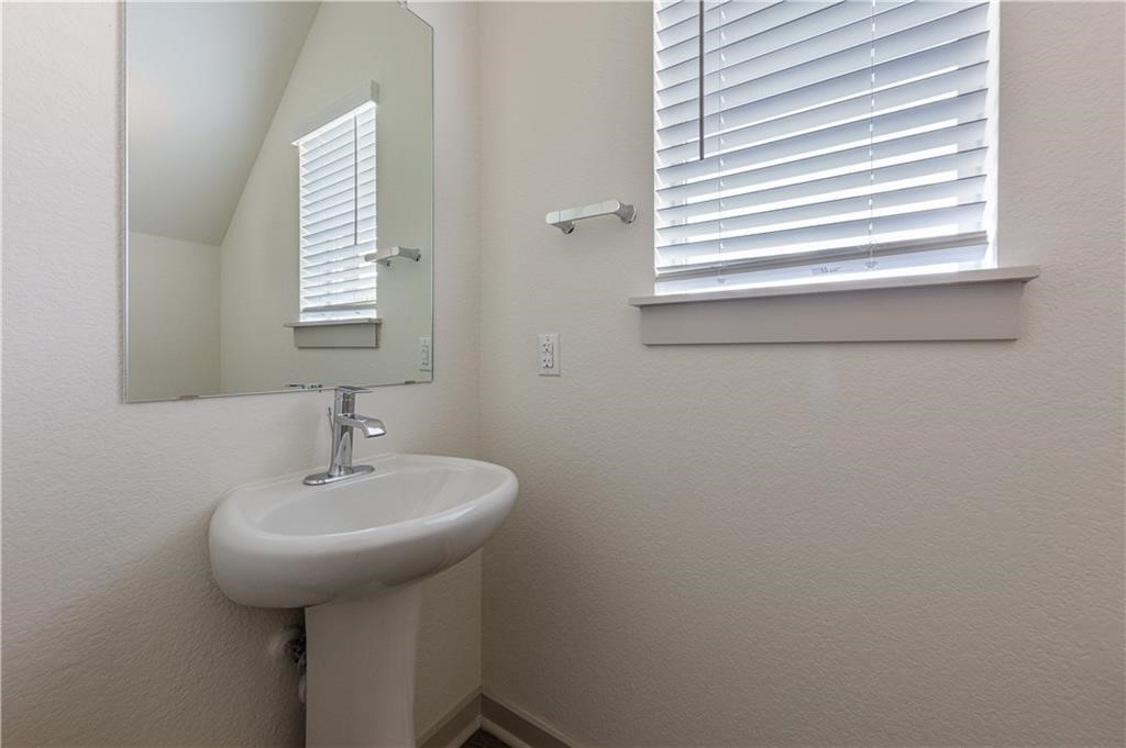 1801 Bonham Lane Round Rock, TX 78664 - Photo 10 of 24 a bathroom with a sink a mirror and a window