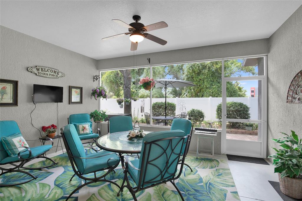 16411 Southwest 14th Avenue Road Ocala, FL 34473 - Photo 33 of 59 a dining room with furniture a large window and a chandelier