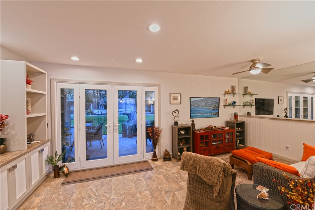 106 Blue Lagoon Laguna Beach, CA 92651 - Photo 14 of 46 a living room with furniture a large window and bookshelf