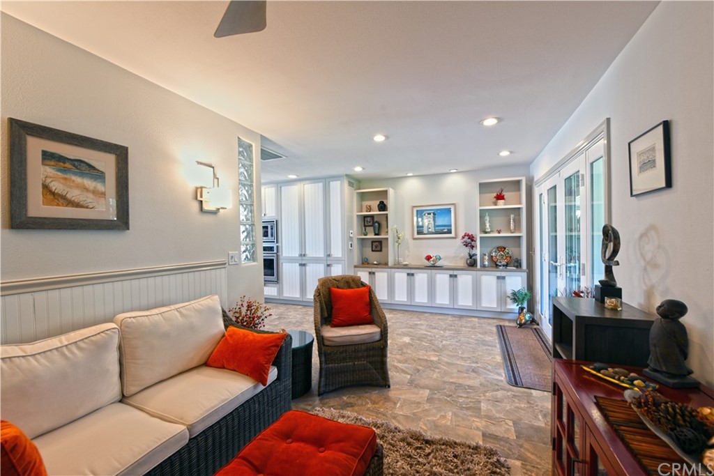 106 Blue Lagoon Laguna Beach, CA 92651 - Photo 15 of 46 a living room with furniture and a flat screen tv