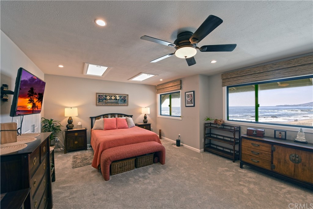106 Blue Lagoon Laguna Beach, CA 92651 - Photo 17 of 46 a bedroom with a bed and a flat tv screen on dresser
