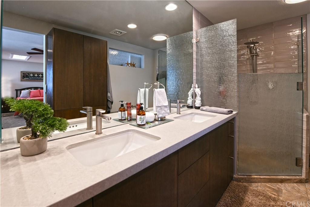 106 Blue Lagoon Laguna Beach, CA 92651 - Photo 20 of 46 a bathroom with a sink a shower and a mirror