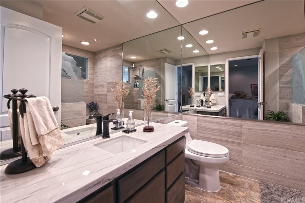 106 Blue Lagoon Laguna Beach, CA 92651 - Photo 23 of 46 a bathroom with a double vanity sink toilet and a tub