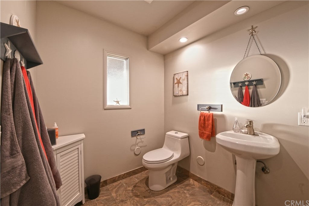 106 Blue Lagoon Laguna Beach, CA 92651 - Photo 27 of 46 a bathroom with a toilet sink and mirror