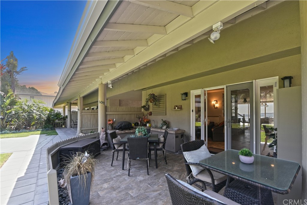 106 Blue Lagoon Laguna Beach, CA 92651 - Photo 9 of 46 a view of a patio with table and chairs and potted plants