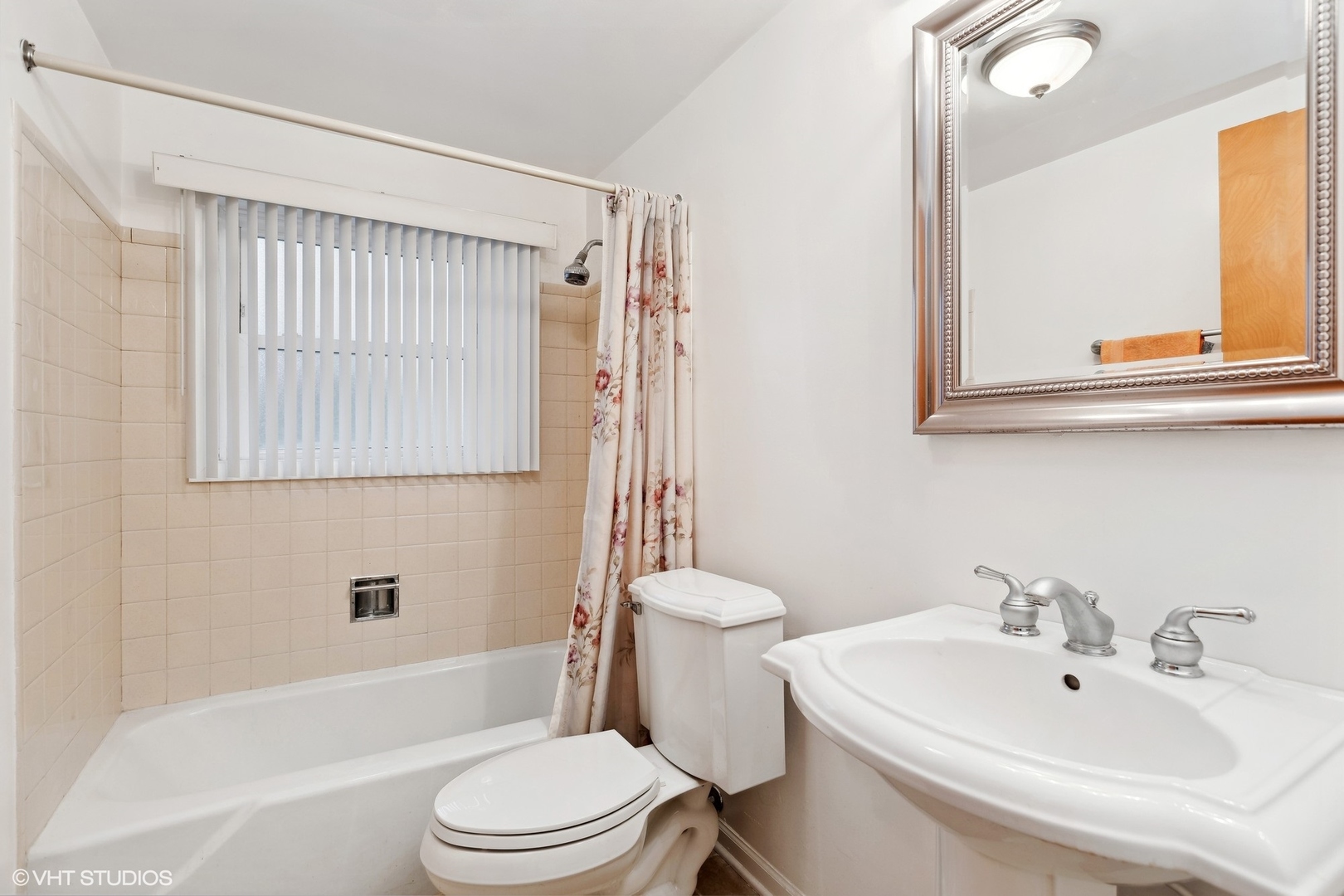 7604 Beckwith Road Morton Grove, IL 60053 - Photo 14 of 20 a bathroom with a sink a toilet and shower