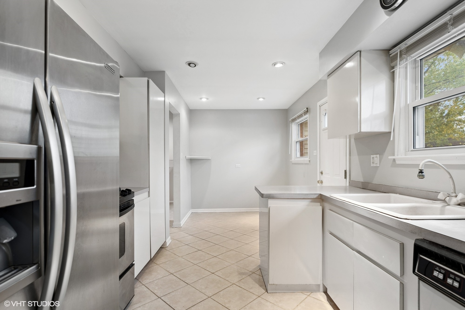 7604 Beckwith Road Morton Grove, IL 60053 - Photo 4 of 20 a kitchen with a sink stainless steel appliances and cabinets