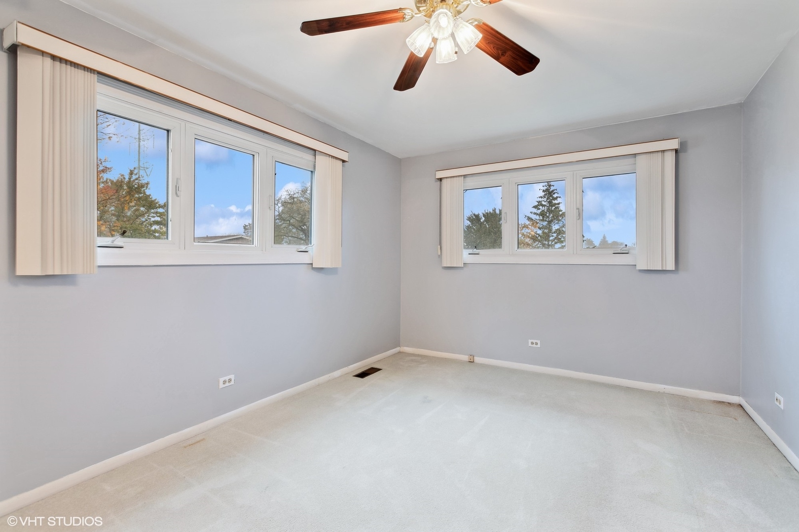 7604 Beckwith Road Morton Grove, IL 60053 - Photo 9 of 20 a view of an empty room with a window and a painting on the wall
