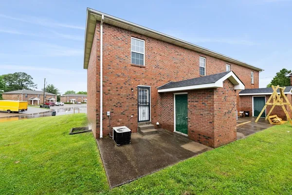 a view of a house with a backyard